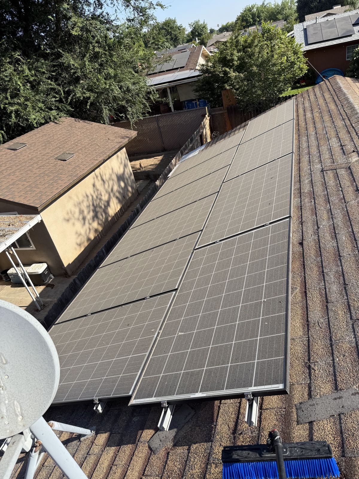Solar panels dulled by a heavy layer of Central Valley dust before cleaning